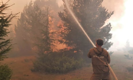 A firefighter trying to extinguish wildfire in the republic of Yakutia, Russia, in August 2021. 