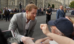 Prince Harry greets wellwishers outside Windsor Castle on Friday evening before his wedding the next day.