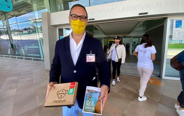 João Fernandes, head of the Algarve tourism, welcomes visitors at Faro airport on Monday.