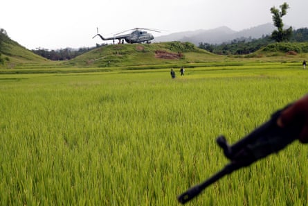 A Myanmar army helicopter transports journalists to an area where government forces found the bodies of Hindu villagers, whom the authorities claim were killed by insurgents last month