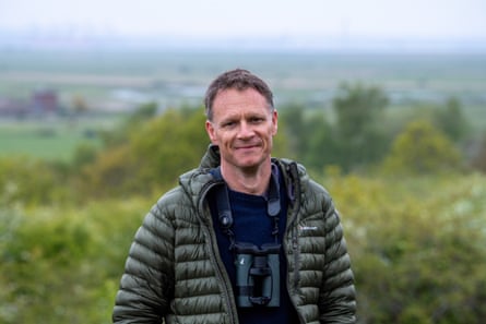 Johnson in a rural landcape with binoculars