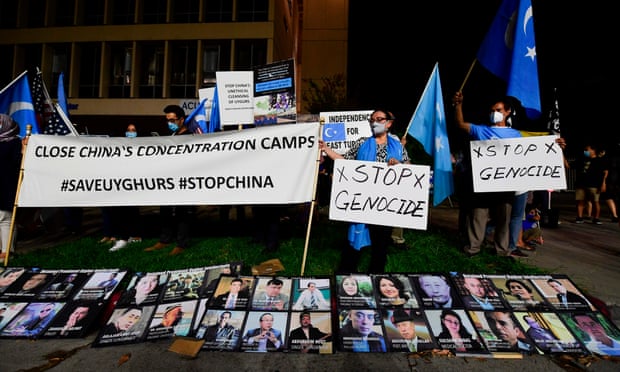 Protesters in Los Angeles display photographs of prominent Uighur intellectuals detained by China during a global day of action on 1 October.