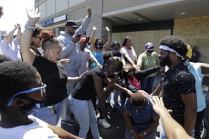 A group prays near the intersection where David McAtee was killed in Louisville, Kentucky, on 2 June.
