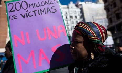 A woman with a placard that reads “200 million victims, no one more” protesting against FGM in Madrid in 2018
