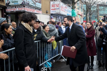 a man shaking another man’s hand