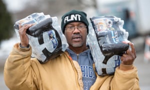 Steve Deloney carries water which he was using for himself and delivering to his sister.