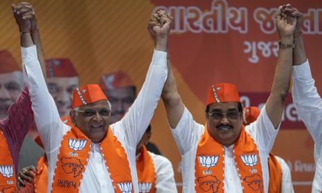 The Gujarat chief minister, Bhupendra Patel, left, and the Gujarat BJP president, CR Patil, celebrate the election results in Gandhinagar