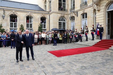 France’s newly appointed prime minister and former minister of armed forces Sébastien Lecornu (R) shakes hands as he is welcomed by outgoing prime minister François Bayrou for the handover ceremony at the Hotel Matignon in Paris on Wednesday.