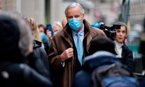 Michel Barnier, wearing a mask, walks to a conference centre in central London