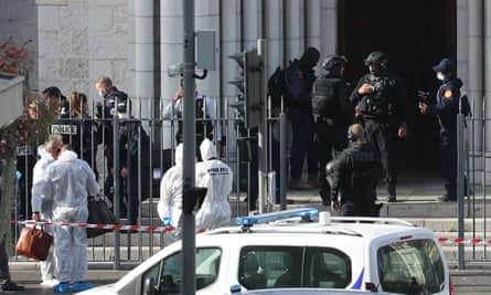 French members of the elite tactical police unit RAID enter to search the Basilica of Notre-Dame de Nice as forensics officers wait outside.