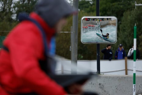 Lucas Rossi of Argentina is reflected in a mirror by the big drop as a judge watches on while taking part in the men’s kayak team event during day one of the ICF Canoe Slalom World Championships 2023 at the Lee Valley White Water Centre.