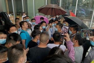 People gathered outside the Evergrande headquarters in Shenzhen, southeastern China, today as the Chinese property giant said it is facing “unprecedented difficulties” but denied rumours that it is about to go under.