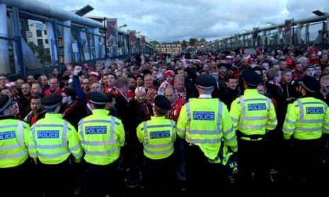 Police hold back fans before the Europa League match between Arsenal FC and Cologne