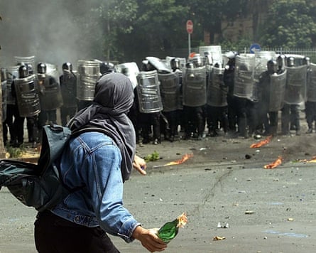 An anti-globalisation protester throws a petrol explosive towards Italian constabulary successful Genoa, 20 July 2001.