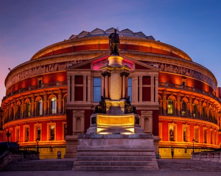 An exterior shot of the Royal Albert Hall lit up as night falls
