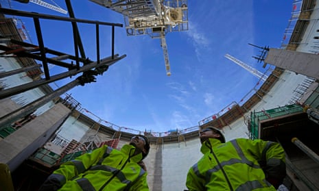 Employees look up at the construction site of Hinkley Point C