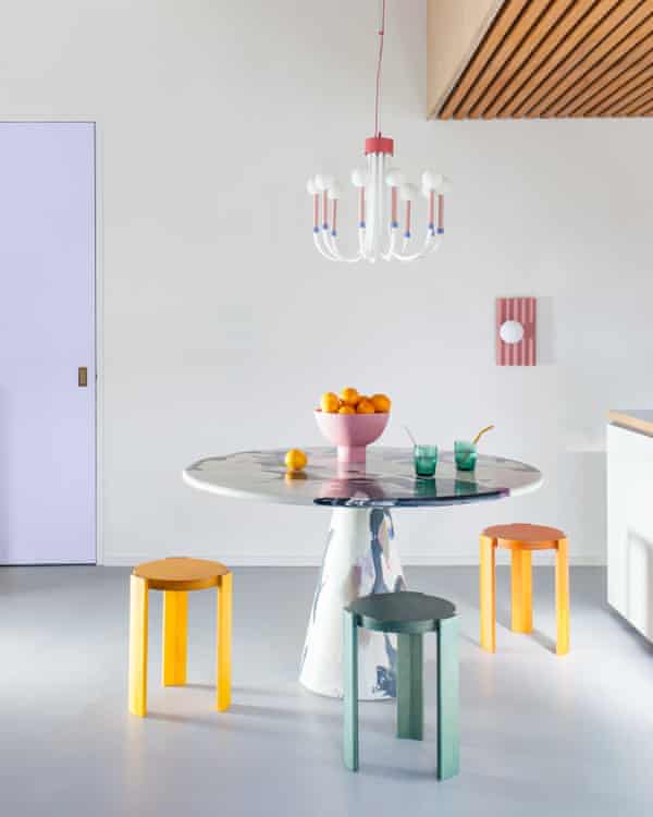 houseof lighting hanging over a table with bright-coloured stools