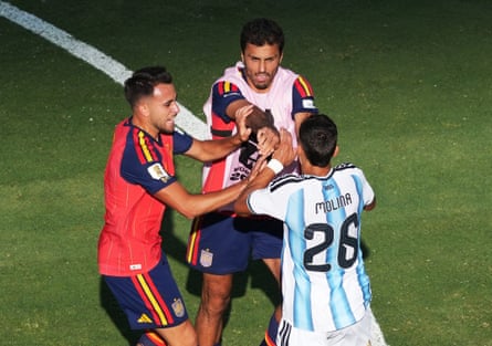 Spain’s Eric Garcia and Rodri argue with Argentina’s Nahuel Molina