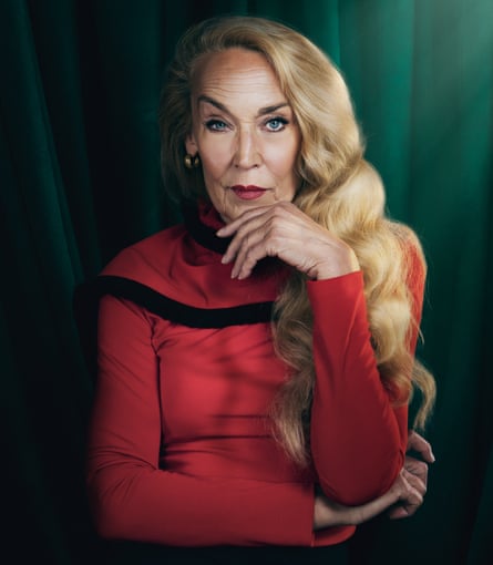 A woman with long blond hair and a red jumper.