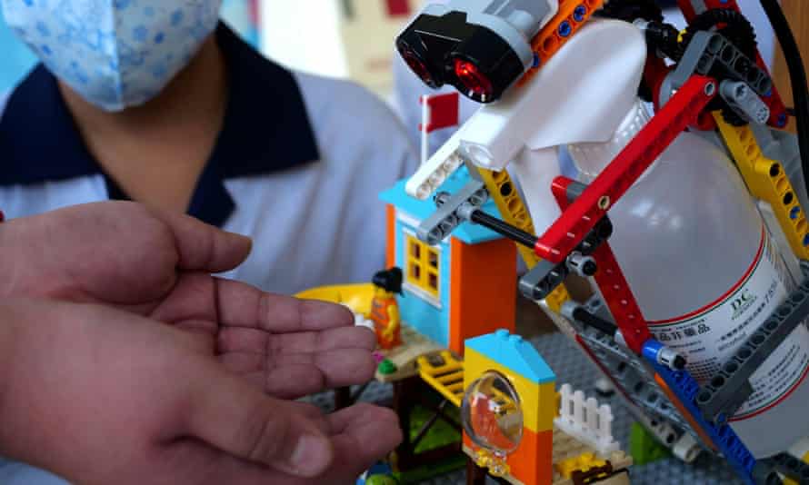 An elementary school student uses a self-built motion sensor controlled disinfectant dispenser assembled with Lego parts, following a novel coronavirus outbreak in the southern Taiwanese city of Kaohsiung