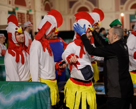 Fans in chicken costumes are searched by security on their way in to Alexandra Palace.