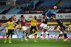 Mings heads the ball over his own bar.