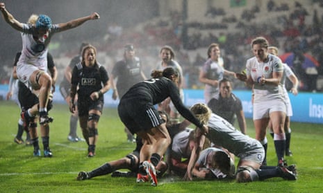 England players celebrate as Marlie Packer, grounded, scores a try