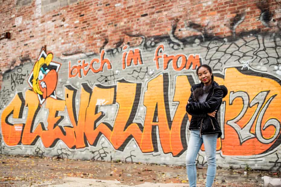 Shatara Jordan, 18, poses in front of graffiti on an abandoned building in Cleveland, Ohio.
