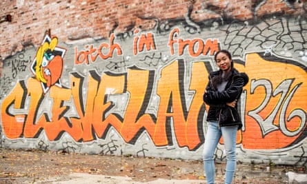 Shatara Jordan, 18, poses in front of graffiti on an abandoned building in Cleveland, Ohio.