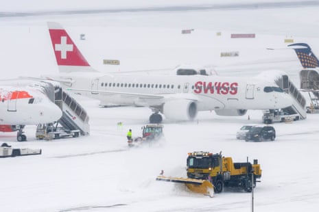 Snow ploughs clear runways at Geneva airport, Switzerland