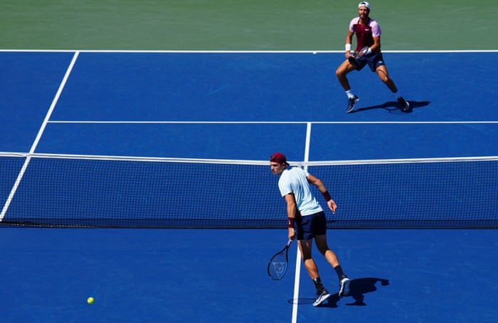 Karen Khachanov (top) hits a shot past Jack Draper.