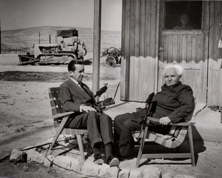 two men sit in outside a building
