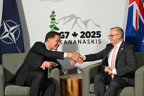 Two men shake hands.