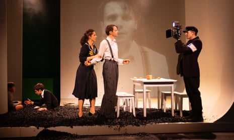 The couple have their photo taken by a man wearing a Star of David armband, while the boys play in the background