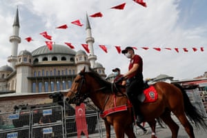 Members of Istanbul Police Department Mounted Unit patrol against people not wearing protective face masks at Taksim Square.