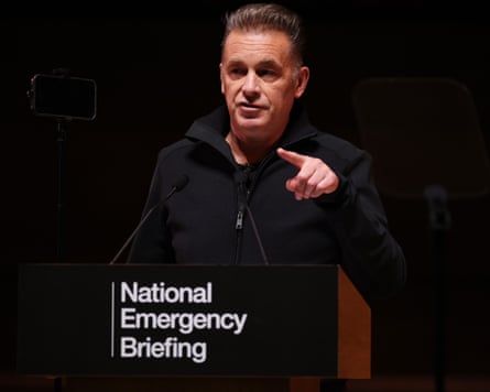 Chris Packham points while speaking at a podium
