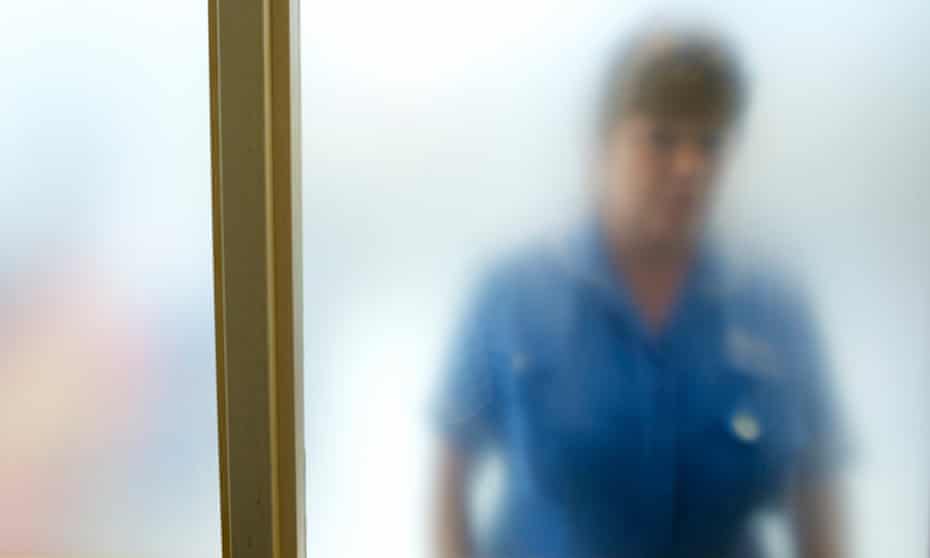A nurse through frosted glass