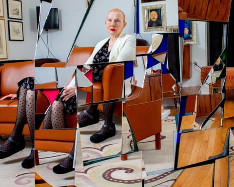 Woman sitting connected orangish leather chair, done fragmented pieces of mirror