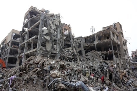 A destroyed building stands against the backdrop of a grey sky.