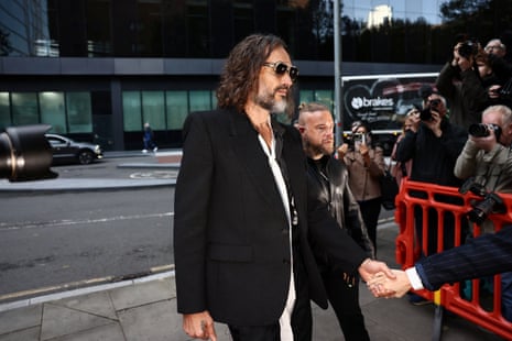 Russell Brand walking towards court.