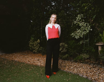 Phoebe standing in a garden looking at the camera with her hands behind her back