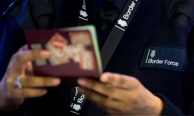 A Border Force officer checks a passport at Heathrow airport.
