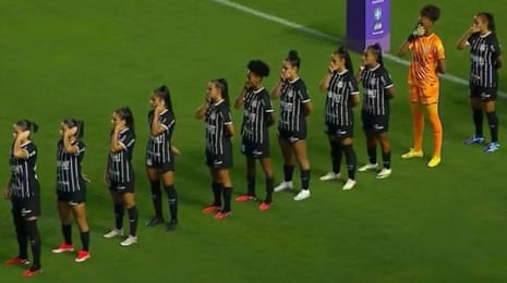 Corinthians’ players cover their ears and mouths in protest before their game against Santos