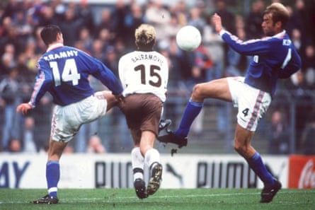 Jürgen Klopp (right) throws in a meaty tackle while playing for Mainz