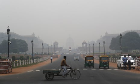 A cyclist paddles his cart as the city envelops in smog in New Delhi, India, in November 2019