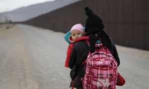 A Central American woman walks along the border in El Paso, Texas on 1 February.