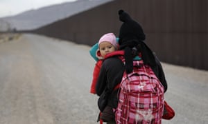 A Central American woman walks along the border in El Paso, Texas on 1 February. 