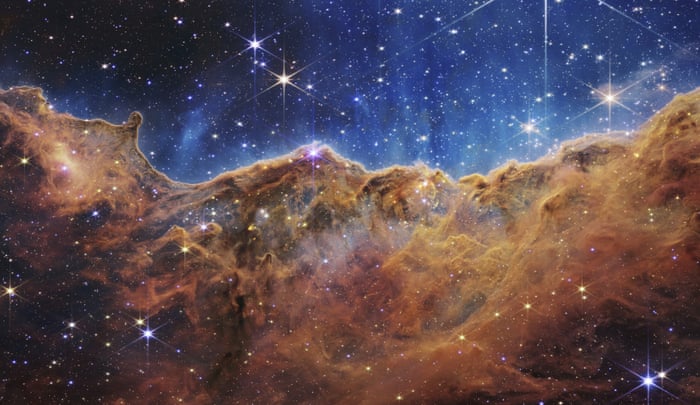 This image shows the edge of a nearby, young, star-forming region NGC 3324 in the Carina Nebula. Captured on the James Webb Space Telescope, this image reveals previously obscured areas of star birth, according to NASA.
