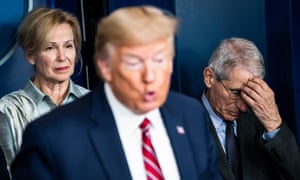 Drs Deborah Birx and Anthony Fauci listen as Donald Trump speaks at the White House on 20 March.