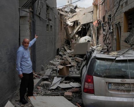 A man points into a destroyed building that was hit in an Israeli airstrike in Burj el-Shamali, near the southern port city of Tyre on 26 May 2026